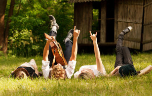 bigstock-Four-Friends-Lying-In-Grass-46228795