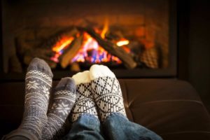 bigstock-Feet-Warming-By-Fireplace-55274456
