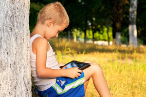 bigstock-Boy-Child-Playing-With-Tablet--49913111